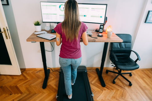 Woman using under-desk treadmill.