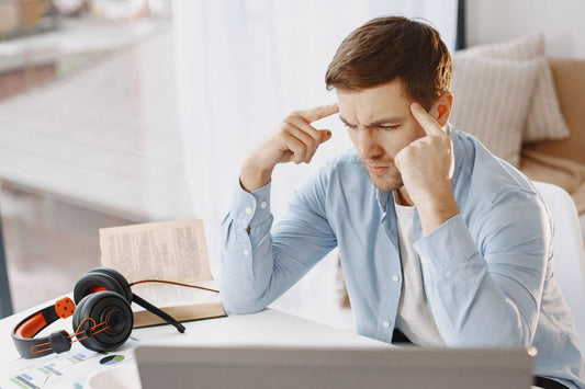 Man concentrating at his desk. 