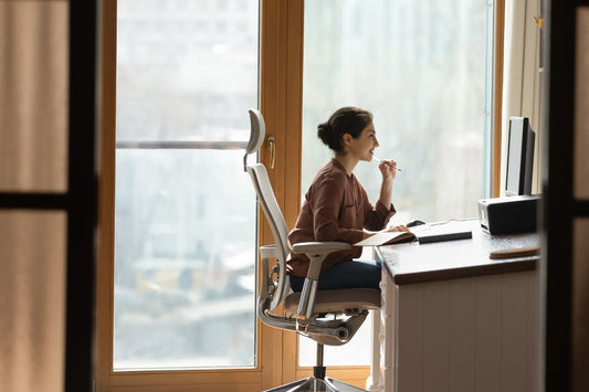 Woman sat at a desk in an ergonomic chair