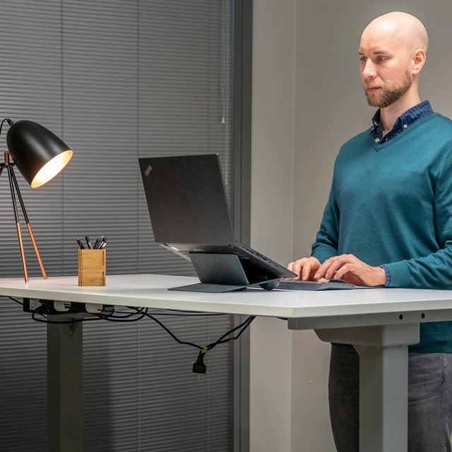 man at standing desk using Ulrika Black Adjustable Laptop Stand