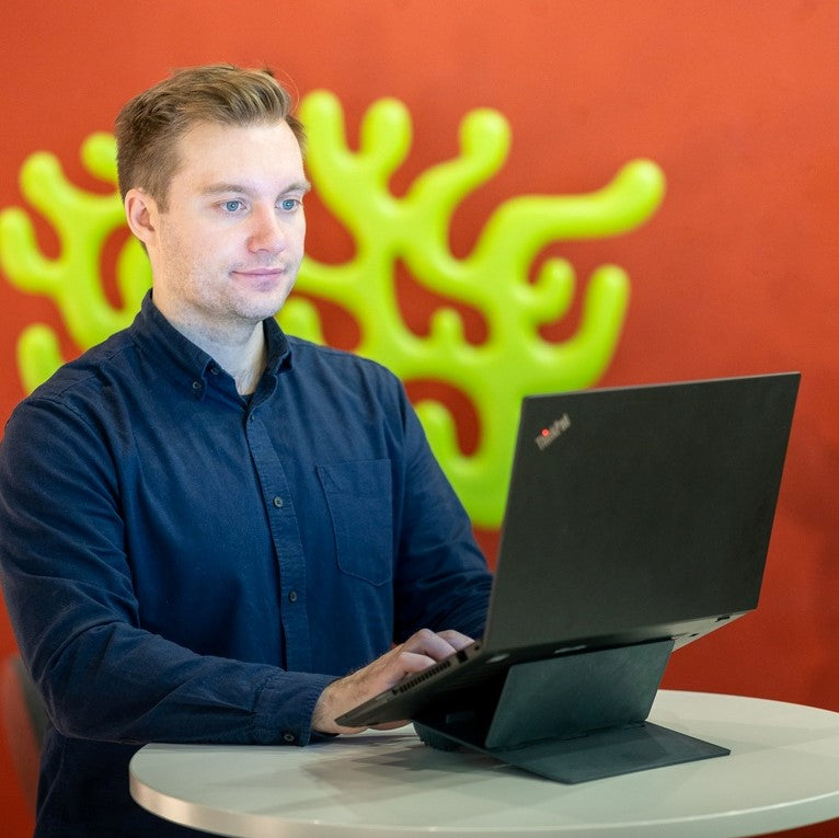 man at work using Ulrika Black Adjustable Laptop Stand