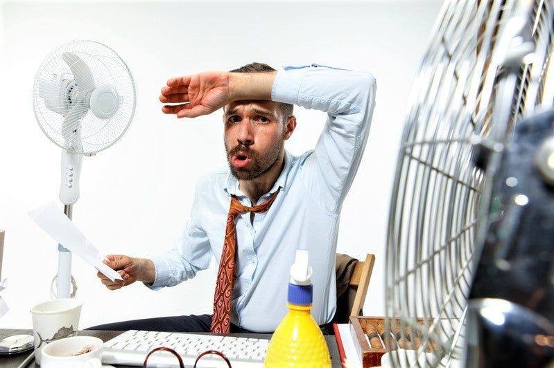 Man hot at his desk.