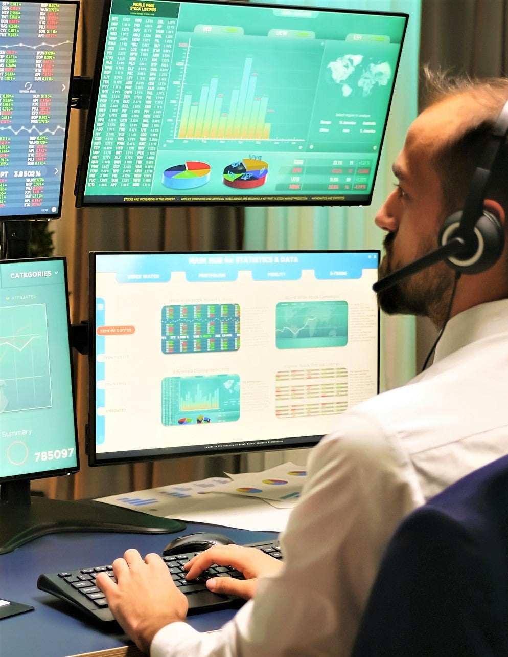 Man sat at a desk using dual monitor.