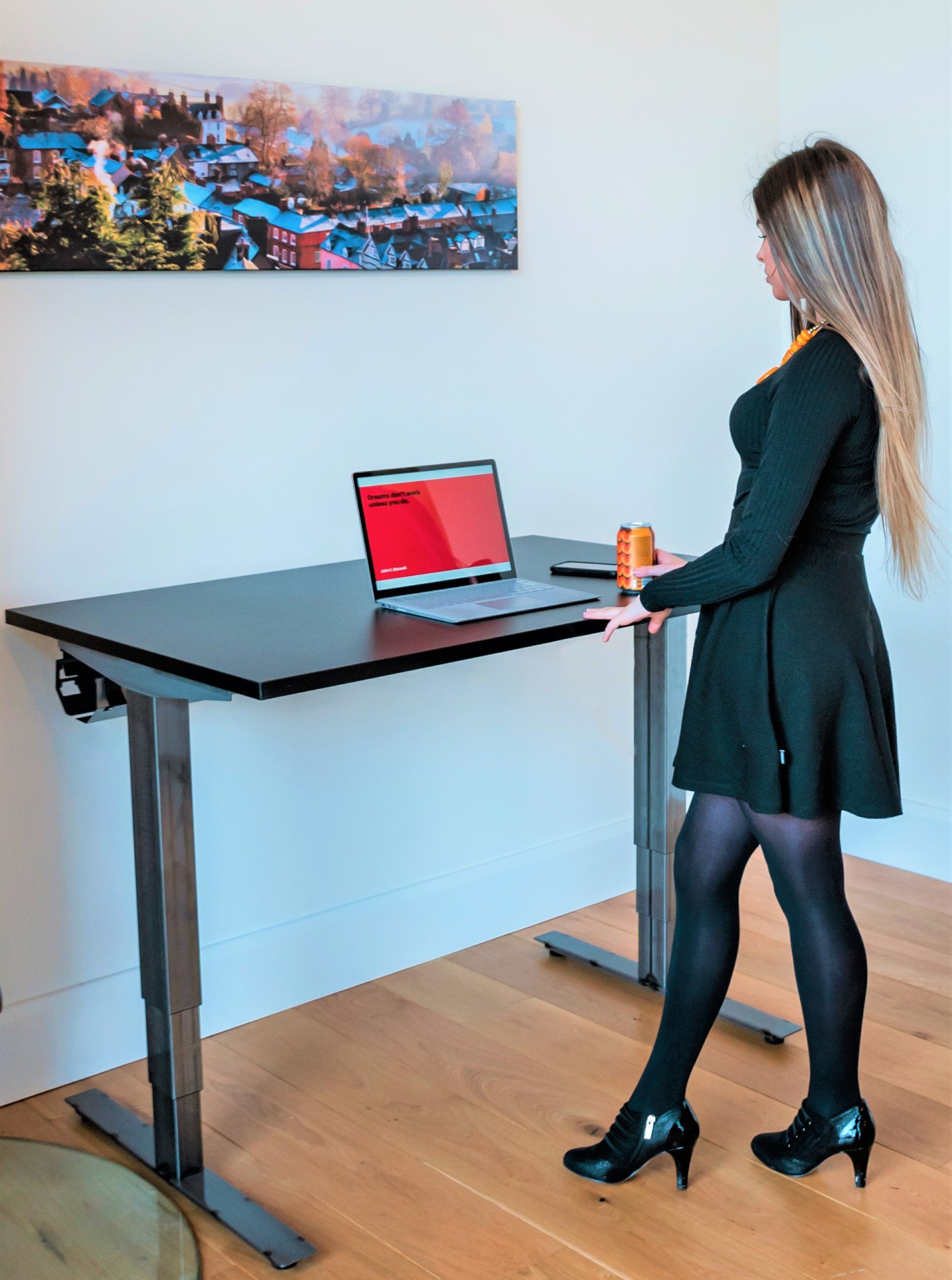 Woman in heels standing at a standing desk.