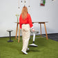 Woman carrying white Younit sit stand stool to standing desk