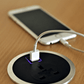 Phone being charged by the Flon In-Desk Power Outlet with USB Smart Charge