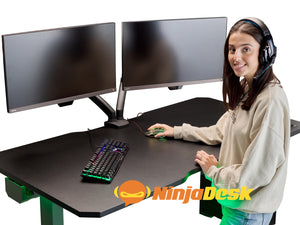 Woman using NINJA Professional Height Adjustable Gaming Desk (with Bluetooth control).