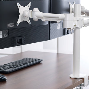 Kalix Single Monitor Arms holding computer monitors on a desk