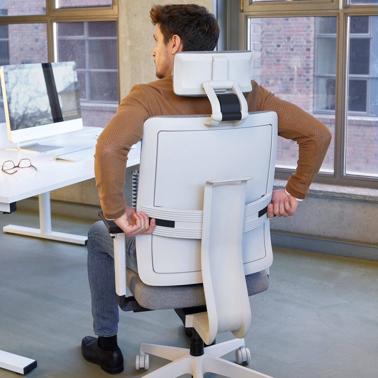 man sitting in grey Viasit Toleo Upholstered-Back Ergonomic Office Chair